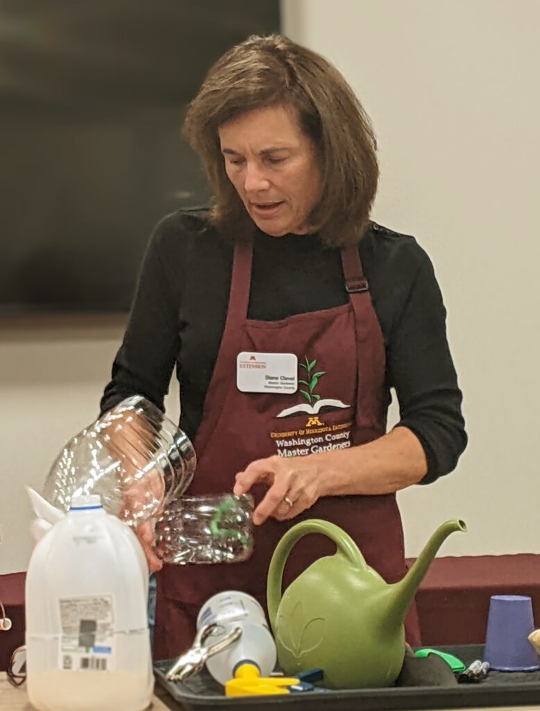 A female volunteer teaches a class about sowing native plant seeds in winter by reusing plastic jugs.